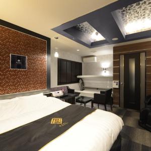 a hotel room with a bed and a bathroom at Hotels & Resort Feel in Yokohama