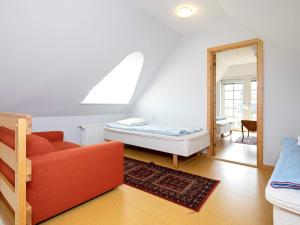 a living room with a bed and a mirror at 8 person holiday home in Blokhus in Blokhus