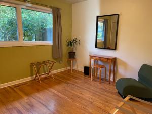 sala de estar con espejo, mesa y sillas en Turnagain Guest House, en Anchorage