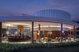 a building with a circular roof with tables and chairs at Avani Chaweng Samui Hotel & Beach Club in Chaweng