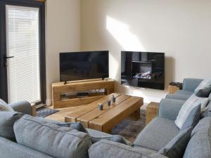 a living room with two couches and a coffee table at Juniper Lodge - UKC3931 in Otterburn