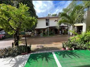 a house with a green court in front of a street at Coron Ecolodge in Coron