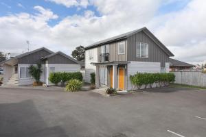 a house with a parking lot in front of it at Arena Lodge in Palmerston North
