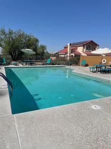 a swimming pool with blue water in a yard at The Desert Oasis at #LambertPark Tucson - 4BD + Unobstructed Mountain Views in Tucson