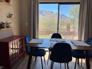 a dining room with a table and chairs and a window at The Desert Oasis at #LambertPark Tucson - 4BD + Unobstructed Mountain Views in Tucson
