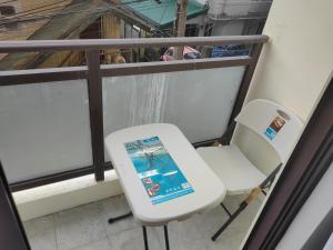 a white chair sitting next to a window at Salcedo's Units in Baguio