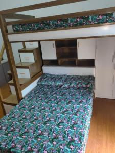 a bunk bed with a floral bedspread on it at Salcedo's Units in Baguio