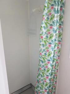 a pair of pants with flowers on them in a room at Beach Break Cabin - short walk to beach and cafes in Waihi Beach