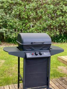 a grill sitting on top of a table at Beach Break Cabin - short walk to beach and cafes in Waihi Beach