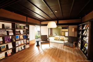 a living room with two chairs and a couch at NIPPONIA HARIMA FUKUSAKI ZOUSHONO YAKATA in Fukusaki