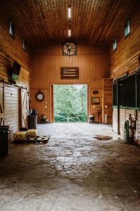 an empty barn with a large doorway and a large window at Treetop Hideaway at Barr5 Ranch in Dunlap