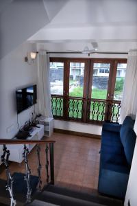 a living room with a view of a balcony at Agosto @Aansav Verde Fatrade Varca GOA 3 BR Villa in Varca