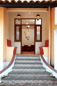 a set of stairs leading to the front door of a house at Agosto @Aansav Verde Fatrade Varca GOA 3 BR Villa in Varca
