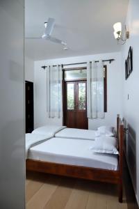 a bedroom with two beds and a window at Agosto @Aansav Verde Fatrade Varca GOA 3 BR Villa in Varca +49 photos