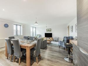 a dining room and living room with a table and chairs at Alnwick Pad in Alnwick