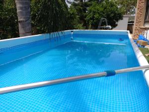 a swimming pool with a paddle in the water at Assaf's place - המקום של אסף in Aẖihud