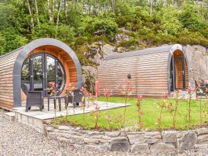 a small cabin with a table and chairs in a garden at Sunart - Uk39865 in Salen