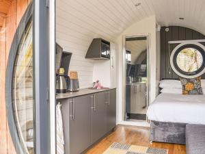 a small kitchen with a bed in a tiny house at Sunart - Uk39865 in Salen