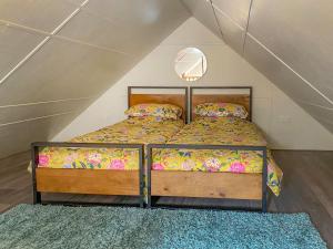a bedroom with a bed in a attic at The Potting Shed in Hinxhill