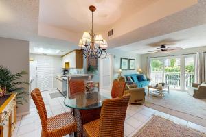 a dining room and living room with a table and chairs at Peaceful Ocean Retreat in East End