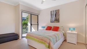 a bedroom with a bed and a balcony at Binda Beauty in Hawks Nest