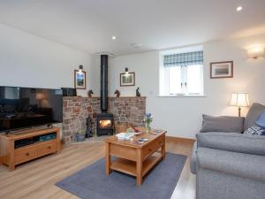 a living room with a couch and a fireplace at Upper Red Down - Uk37699 in Witheridge