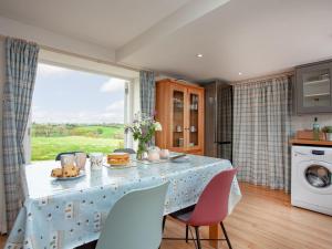 a kitchen with a table with a plate of food on it at Upper Red Down - Uk37699 in Witheridge