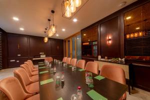 a conference room with a long table and chairs at ELLAA RESIDENCES in Hyderabad