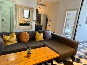 a living room with a couch and a table at Shantell Luxury Apartment in Netanya