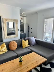 a living room with a couch and a wooden table at Shantell Luxury Apartment in Netanya
