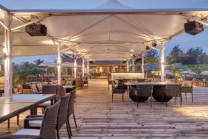 an outdoor dining area with tables and chairs at Mayfair On Sea, Morjim Beach, Goa in Morjim
