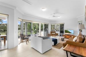 a living room with a couch and a table at Riviera Noosa Resort in Noosaville