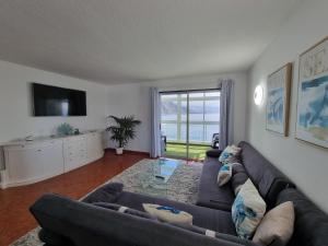 a living room with a couch and a tv at Apartment on the sea in Puerto de la Madera