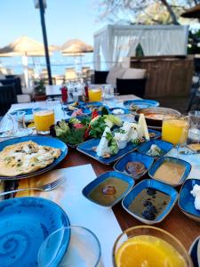 a table with blue plates of food on it at Yalinn Boutique Hotel in Yalıkavak