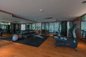 a gym with treadmills and exercise equipment in a building at Patong Beachfront Studio 2 Mins Walk 2 Patong Beach in Patong Beach