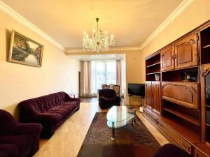 a living room with a couch and a chandelier at Cascade Residence in Yerevan