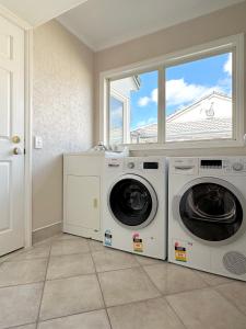 dwie pralki w pokoju z oknem w obiekcie Cheerful 4 bedrooms home with stunning sunshine w Auckland
