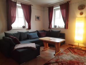 a living room with a couch and a table at Ferienhaus Bad Waltersdorf in Bad Waltersdorf