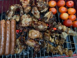 a bunch of meat and sausages on a grill at Kele Yala in Yala