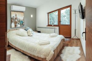 a bedroom with a large bed with two pillows on it at Guest house Anna-Maria in Velingrad