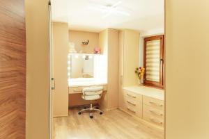 a bathroom with a sink and a desk and a mirror at Guest house Anna-Maria in Velingrad