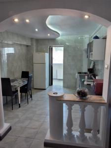 a kitchen with a counter and a table in a room at ZORILOR IMOB in Braşov +6 photos