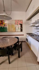 a kitchen with a table and a sink in it at Appartamento Punta Ala in Punta Ala