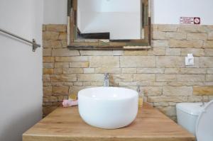 a bathroom with a white sink on a wooden counter at Aris House - Cretan Hospitality in Agios Nikolaos +25 photos