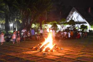 a large fire in the middle of a crowd of people at Les Hameaux de l'Orient in Cu Chi