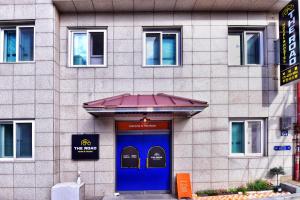 a building with a blue door in front of it at The Road Hotel in Seoul