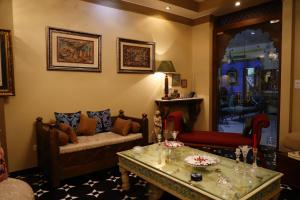 a living room with a couch and a table at Aura Homestay Royal Villa in Jaipur