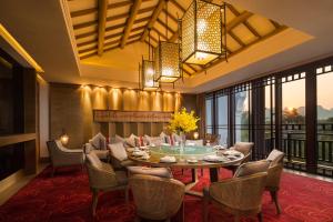 a dining room with a table and chairs at Banyan Tree Yangshuo in Yangshuo