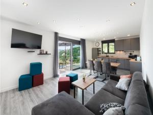 a living room with a couch and a kitchen at Family Holiday Home Nest in Mlini