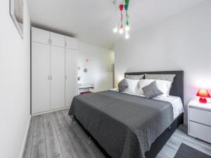 a white bedroom with a large bed and white cabinets at Family Holiday Home Nest in Mlini +33 photos